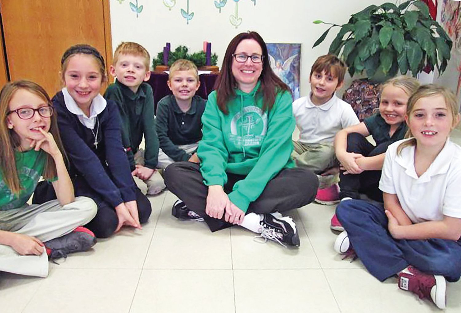 Melinda Osentowski, the new principal of Holy Cross School in Cuba, gathers with a few of the students.